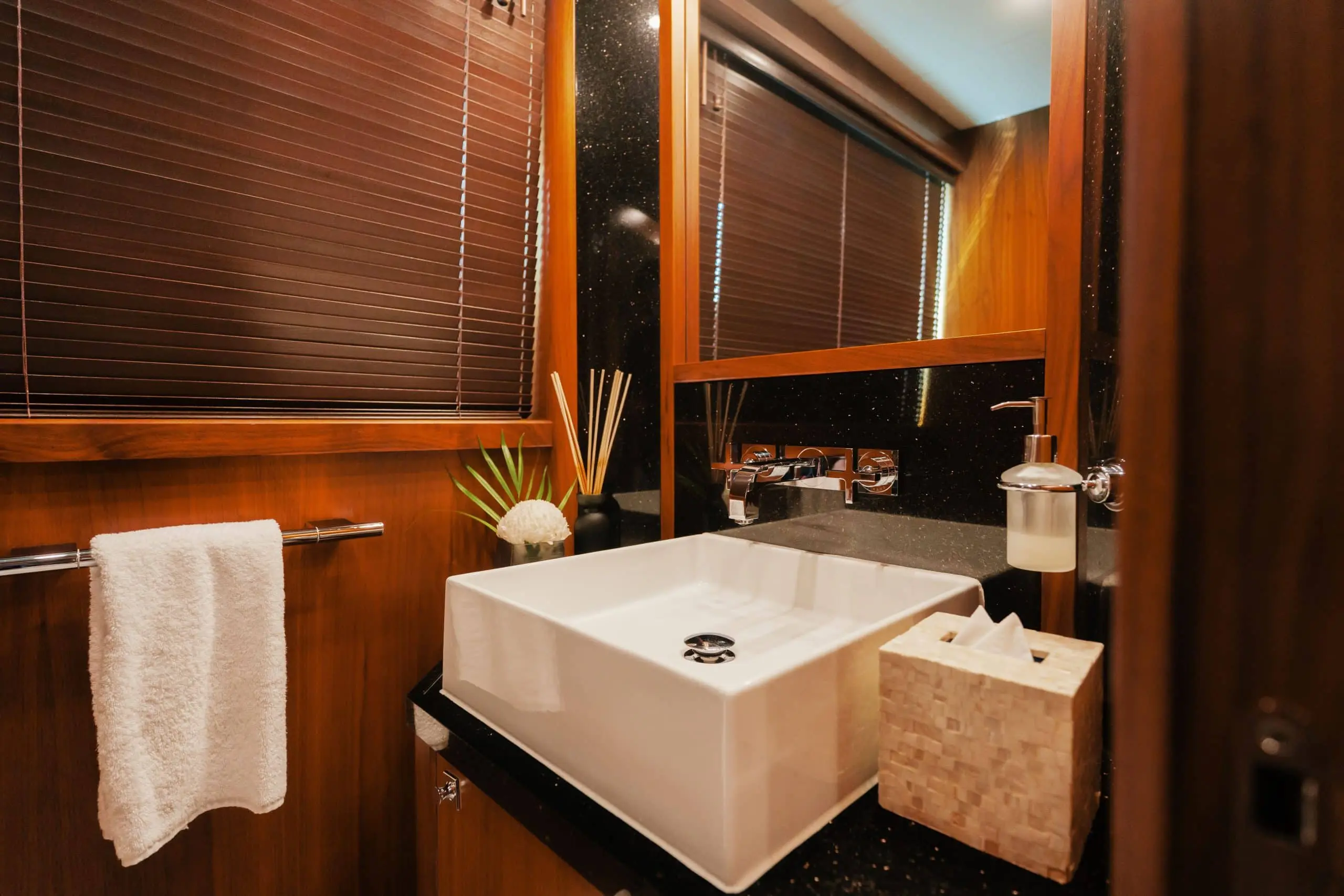 Aurora 130 yacht bathroom with marble countertop and wood cabinetry
