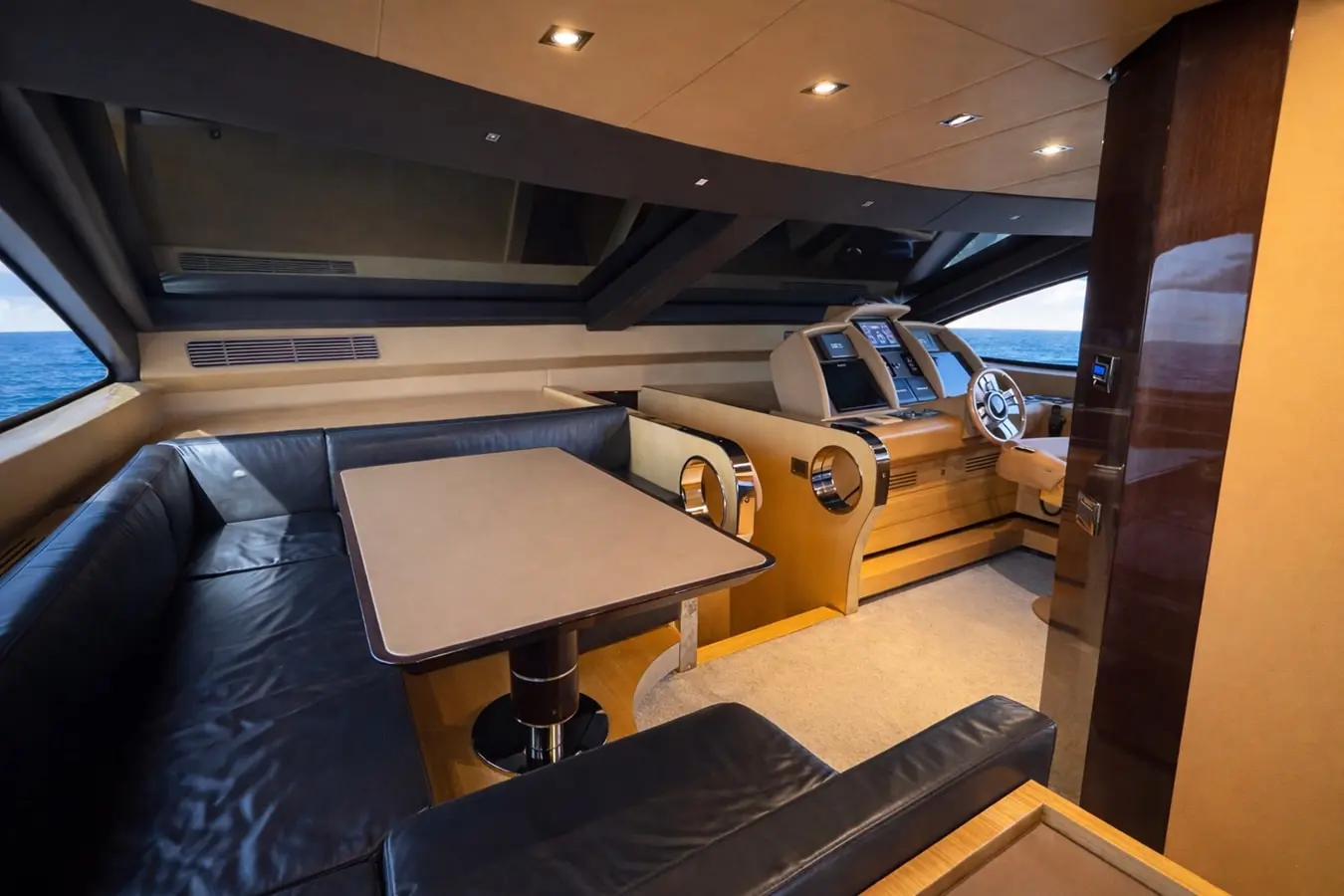 Azimut 88 raised pilothouse dinette beside the main helm