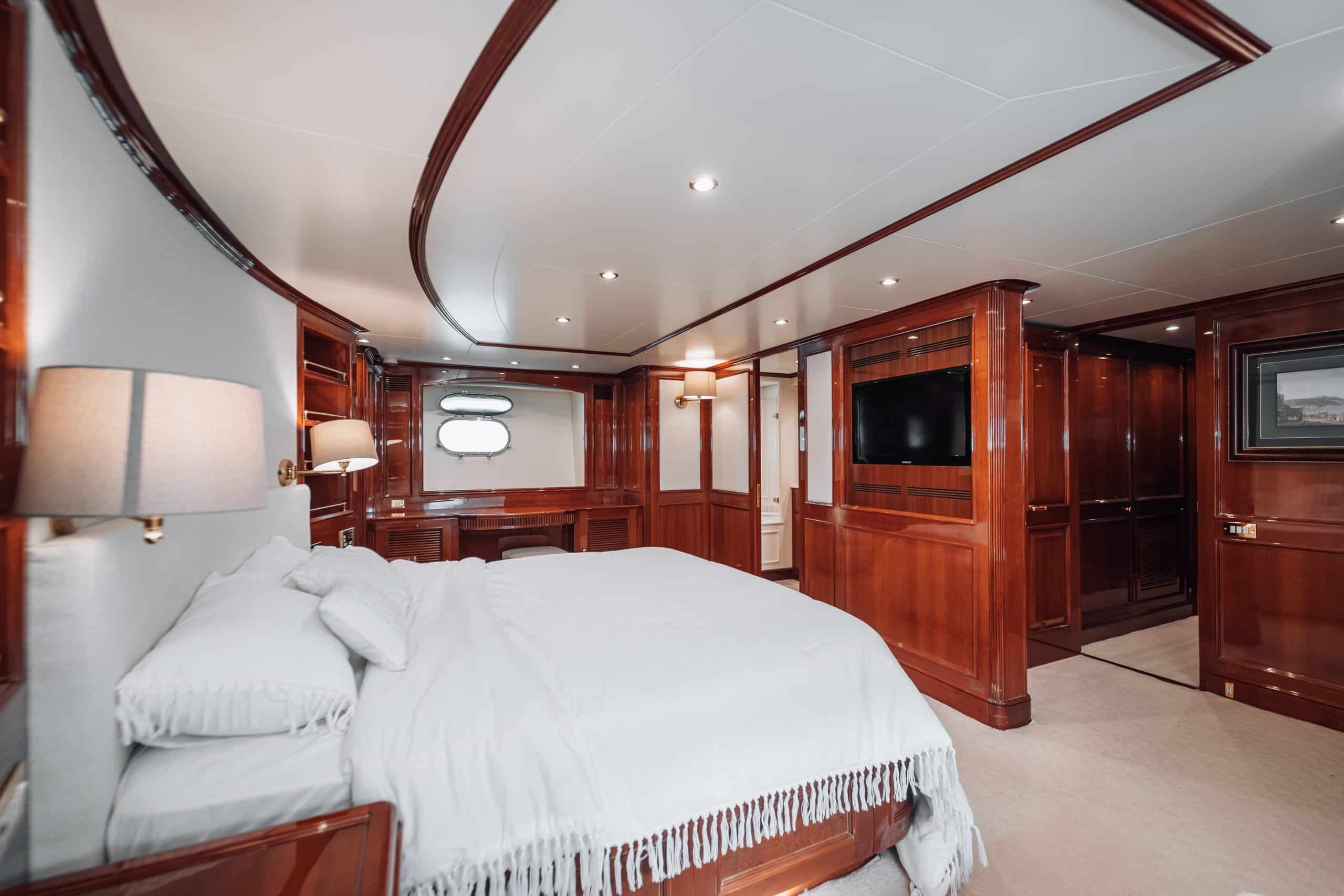 VIP guest cabin on Royal Mirage yacht with ensuite and wood paneling
