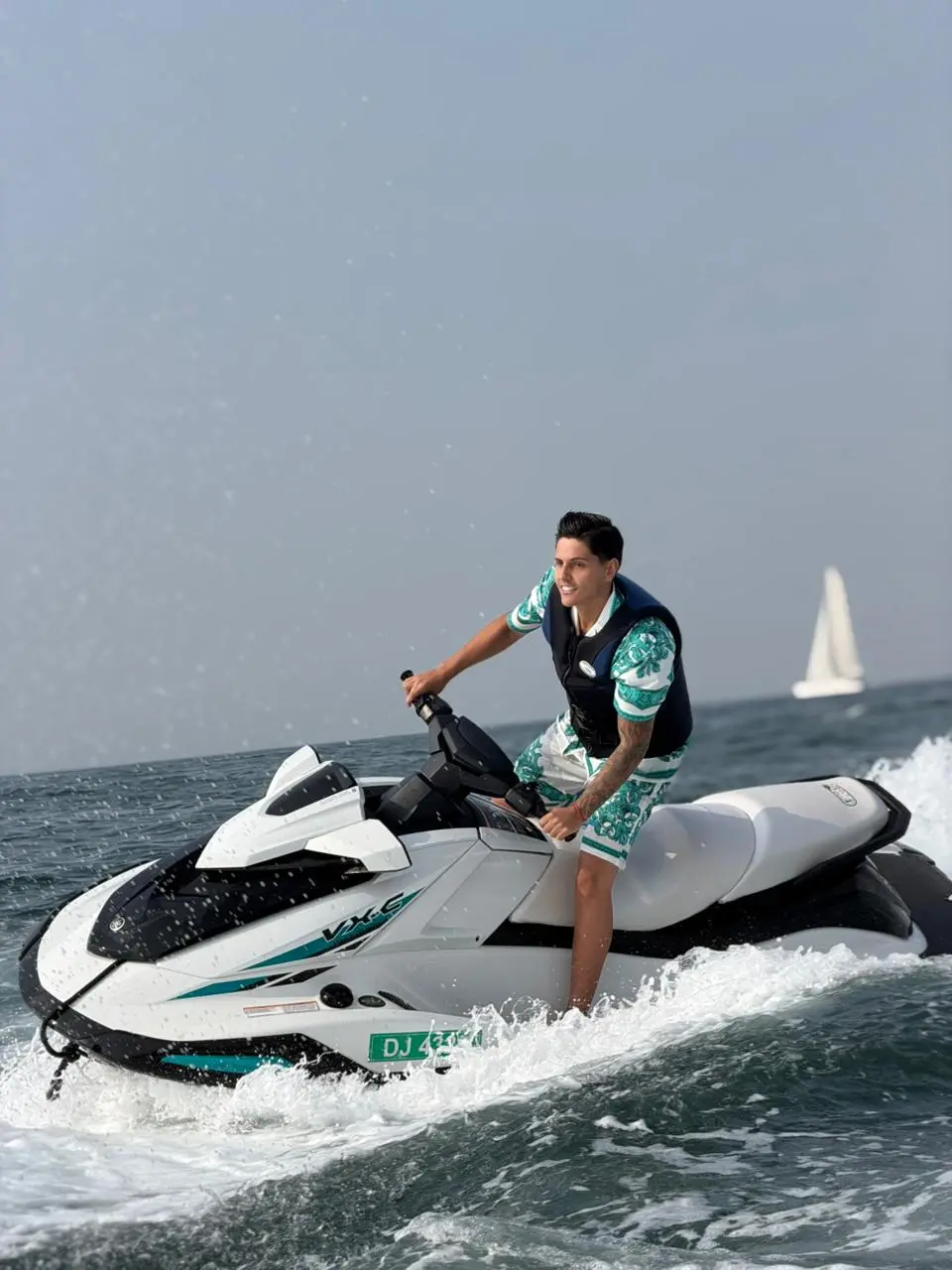 Jet ski rider cruising in Dubai waters with modern buildings in background