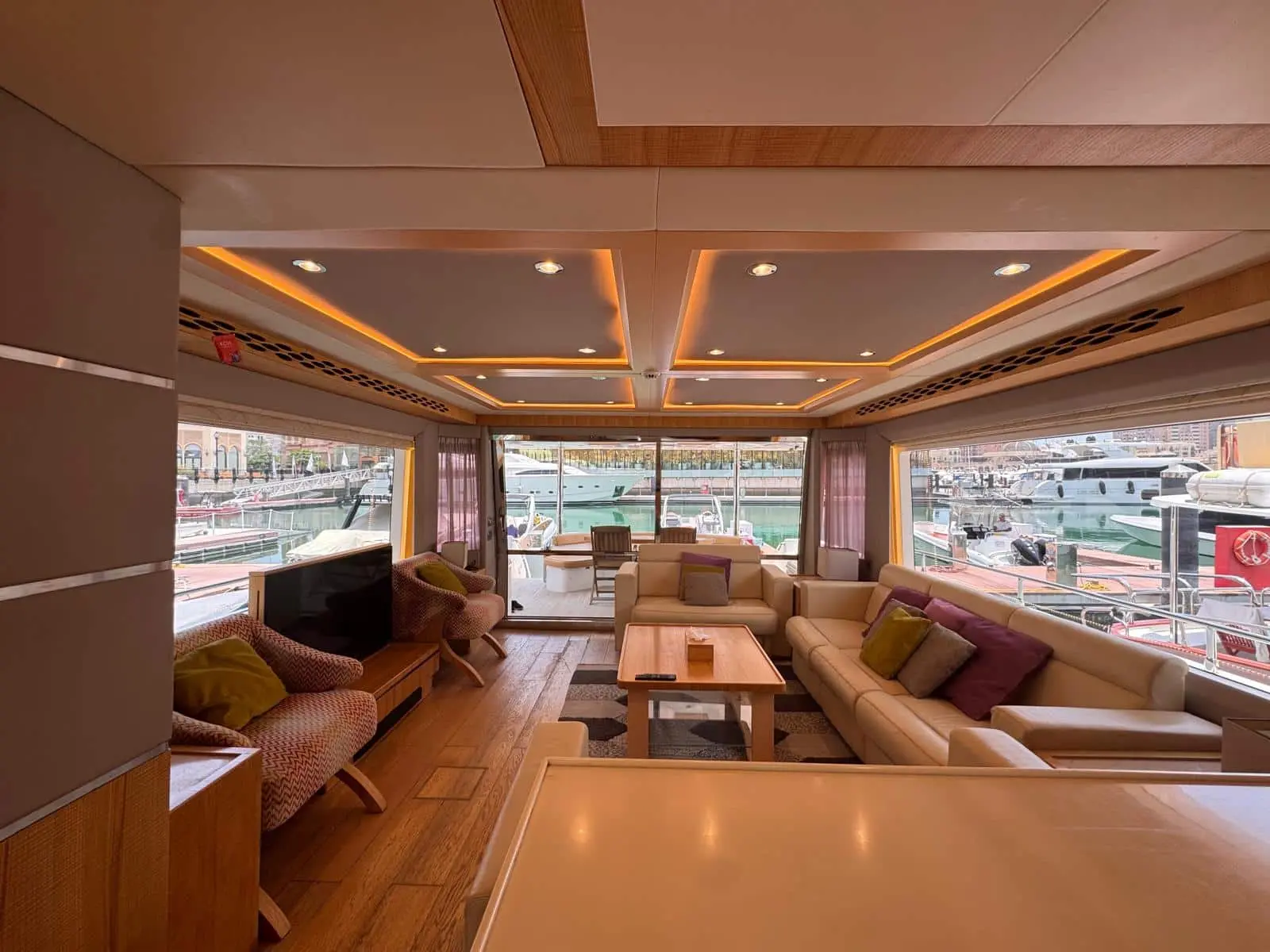 Nomad 65 main saloon with cream leather seating and marina views