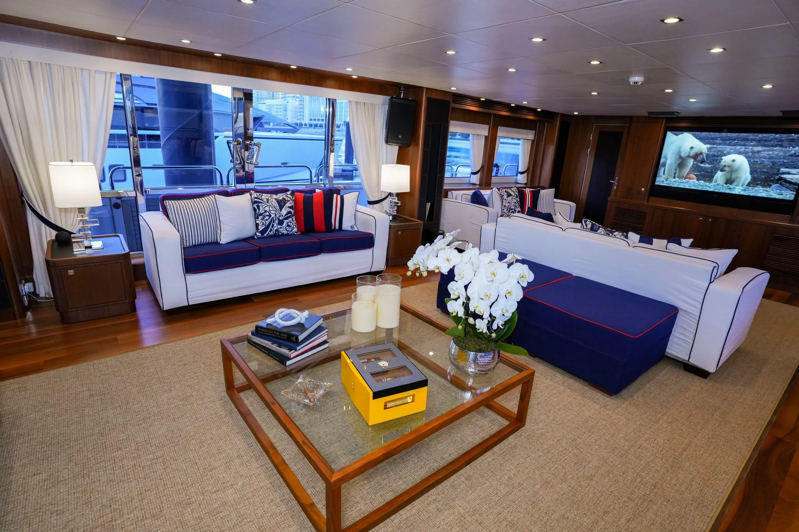 Sunseeker 131 yacht main salon lounge with modern coffee table and blue seating