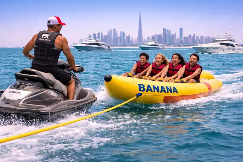 Jet ski towing banana boat ride with tourists enjoying watersports in Dubai