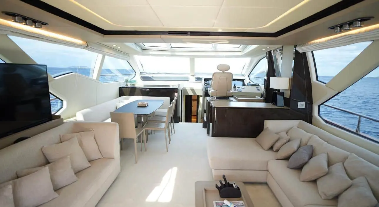 Azimut 77 yacht open-plan salon and dining area with helm station and ocean view