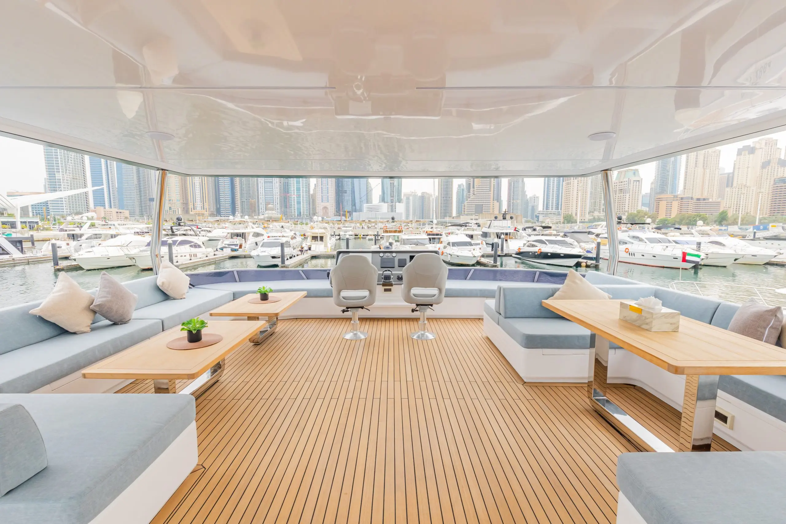 Spacious upper deck seating area on the Zirve 72 yacht with panoramic marina views