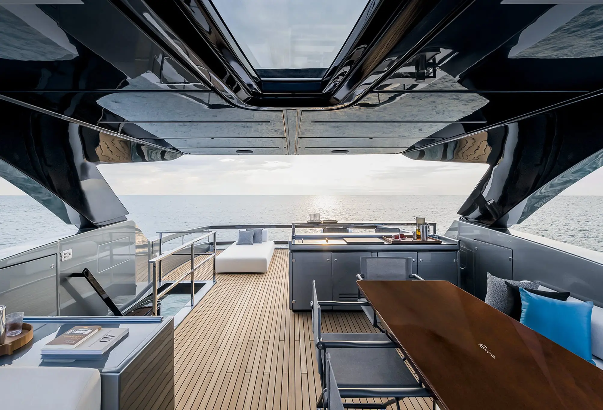 Luxury yacht aft deck with dining area and lounge overlooking open sea