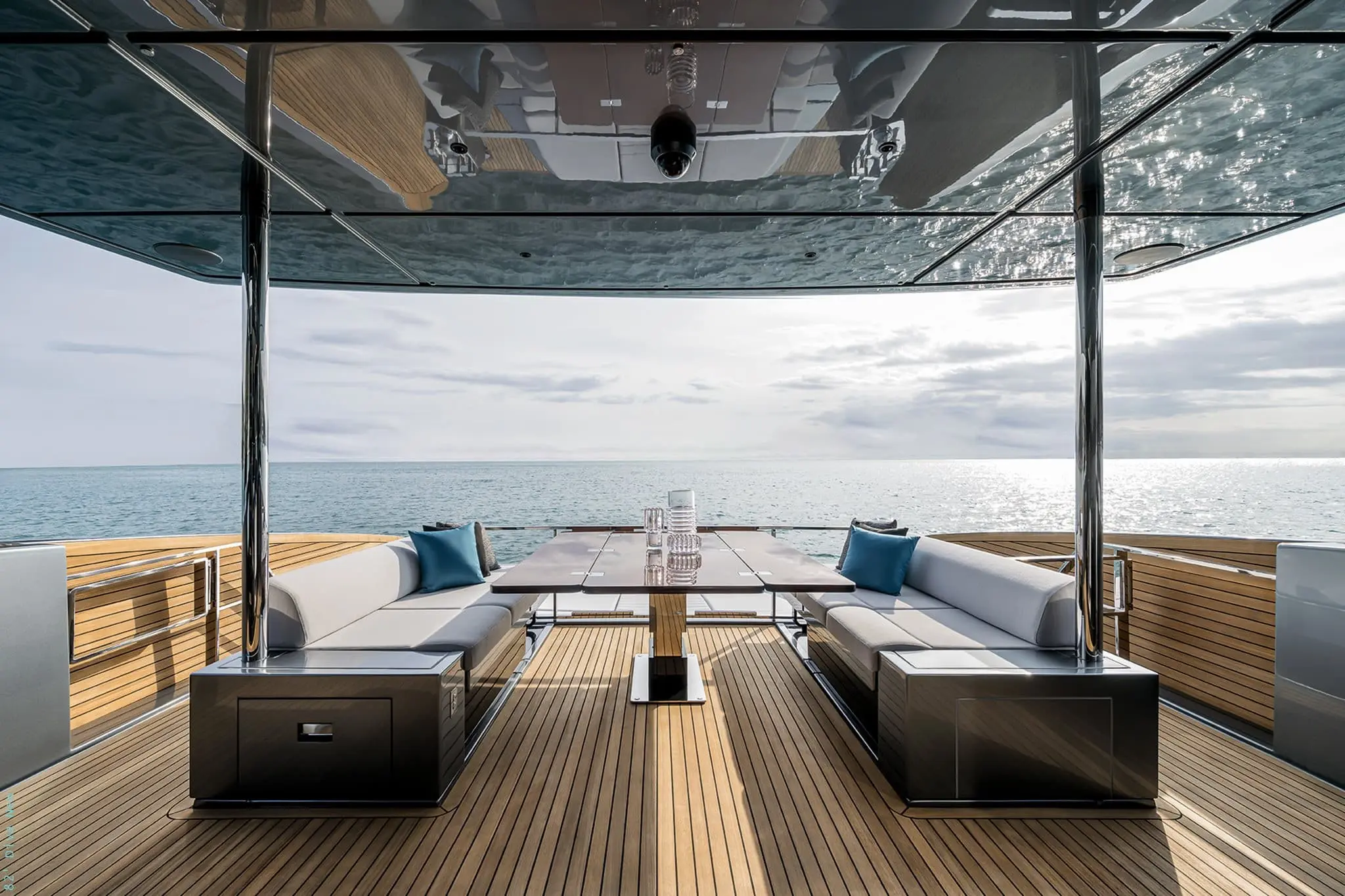 Riva 82 Diva flybridge dining table between twin sofas, sea view