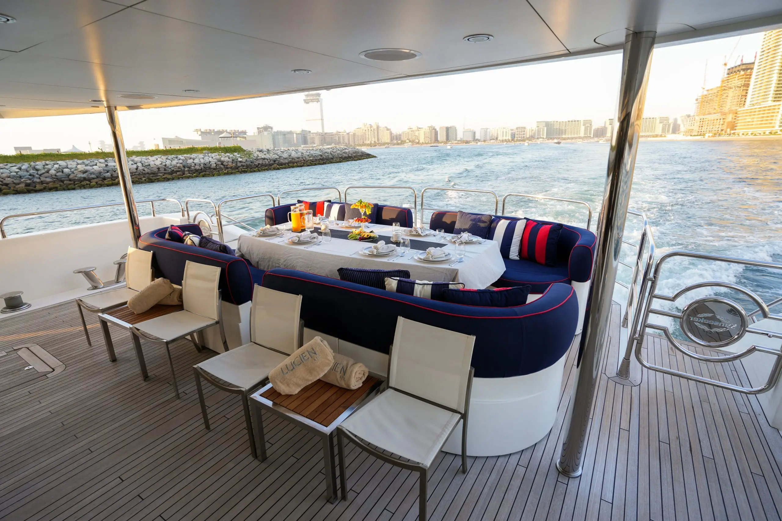 Outdoor dining area on Sunseeker 131 superyacht with large table and cushioned seating