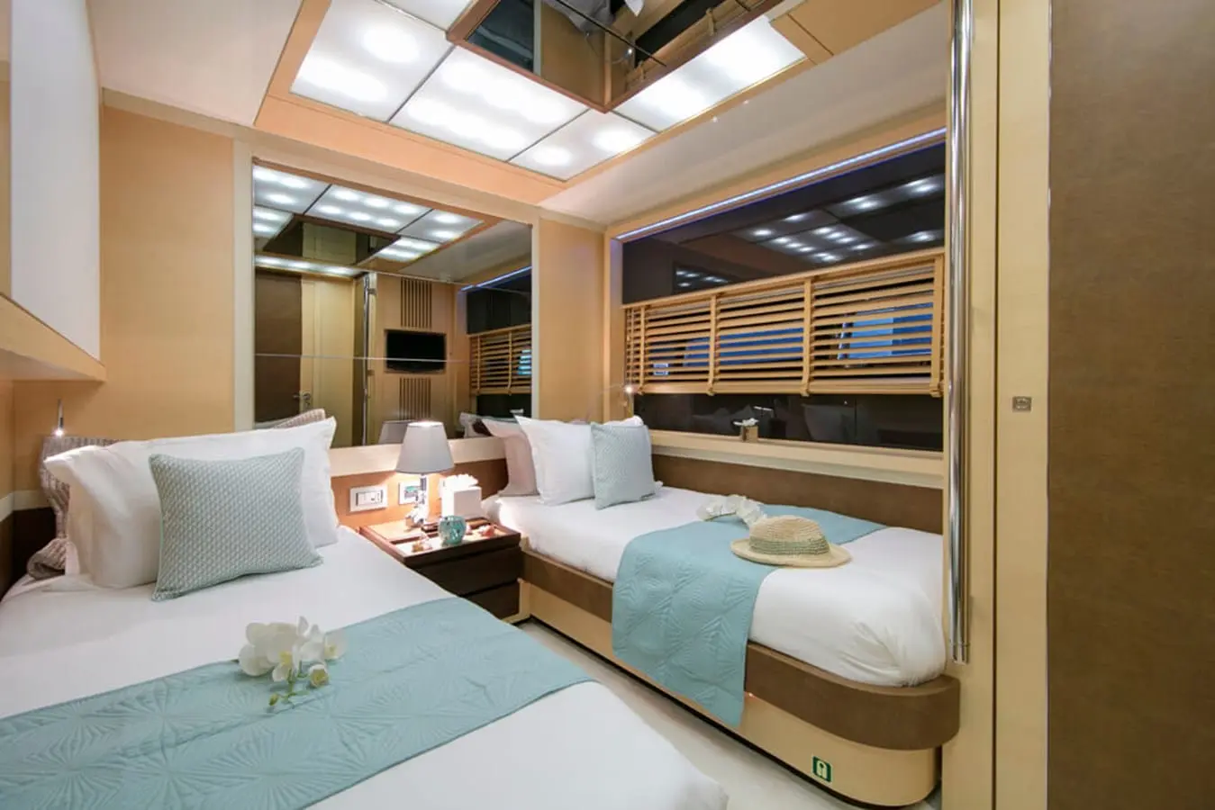 Baia 100 twin guest cabin with two berths and aqua throws