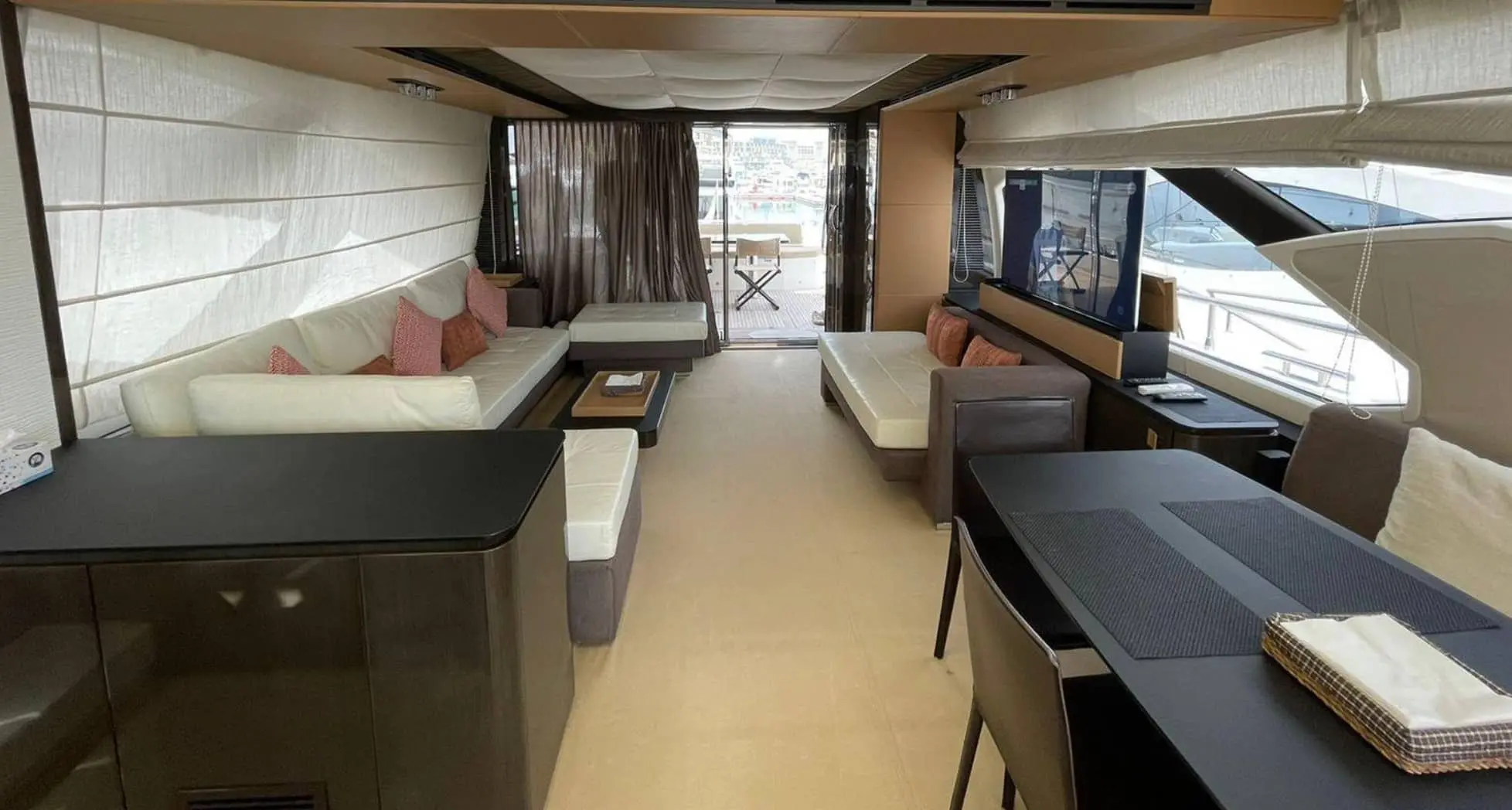 Azimut 77S main saloon looking aft with cream leather sofas