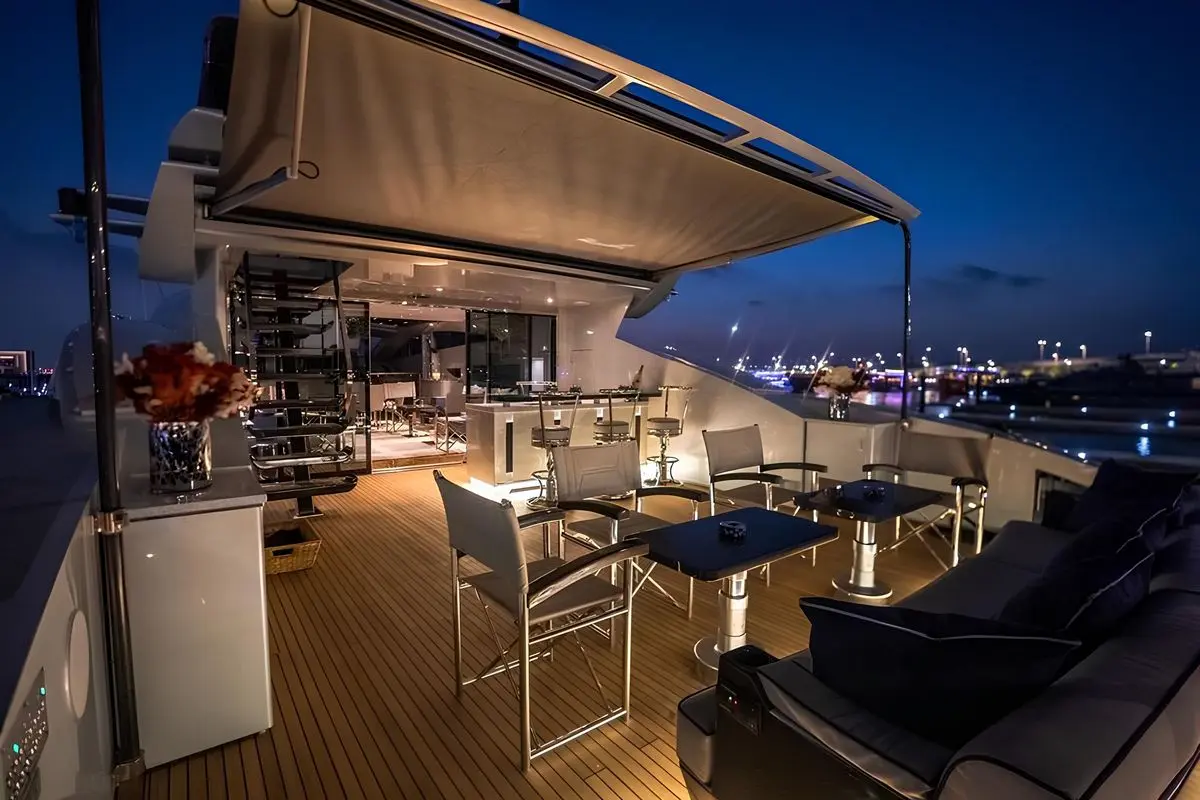 Baglietto 110 yacht evening deck with ambient lighting, teak flooring and luxury outdoor seating