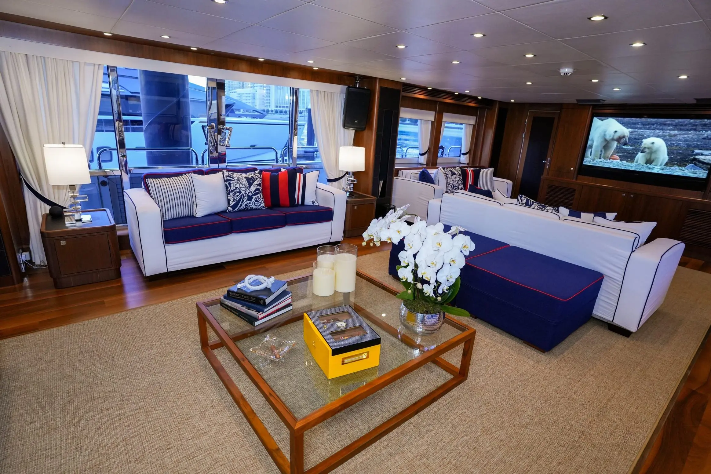 Sunseeker 131 yacht main salon lounge with modern coffee table and blue seating