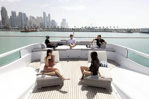 Thunder Superyacht bow lounge with guests enjoying Dubai Marina views