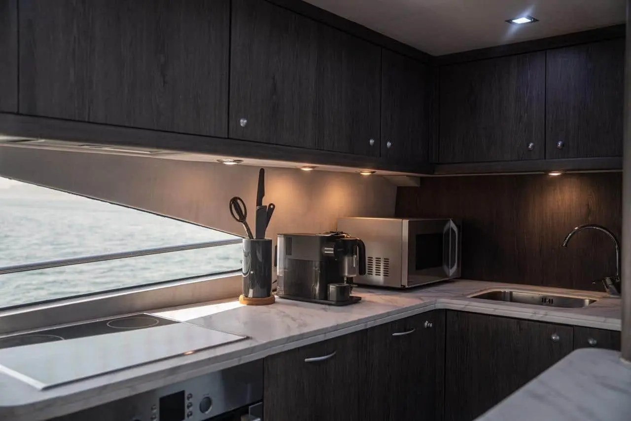 Sunseeker 82 Yacht galley with dark joinery and full appliances
