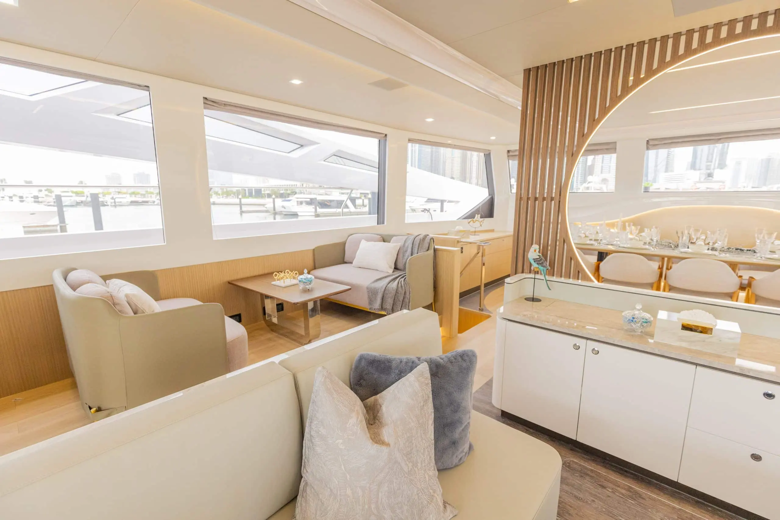 Open-plan saloon interior of Zirve 72 yacht with dining table and wraparound windows