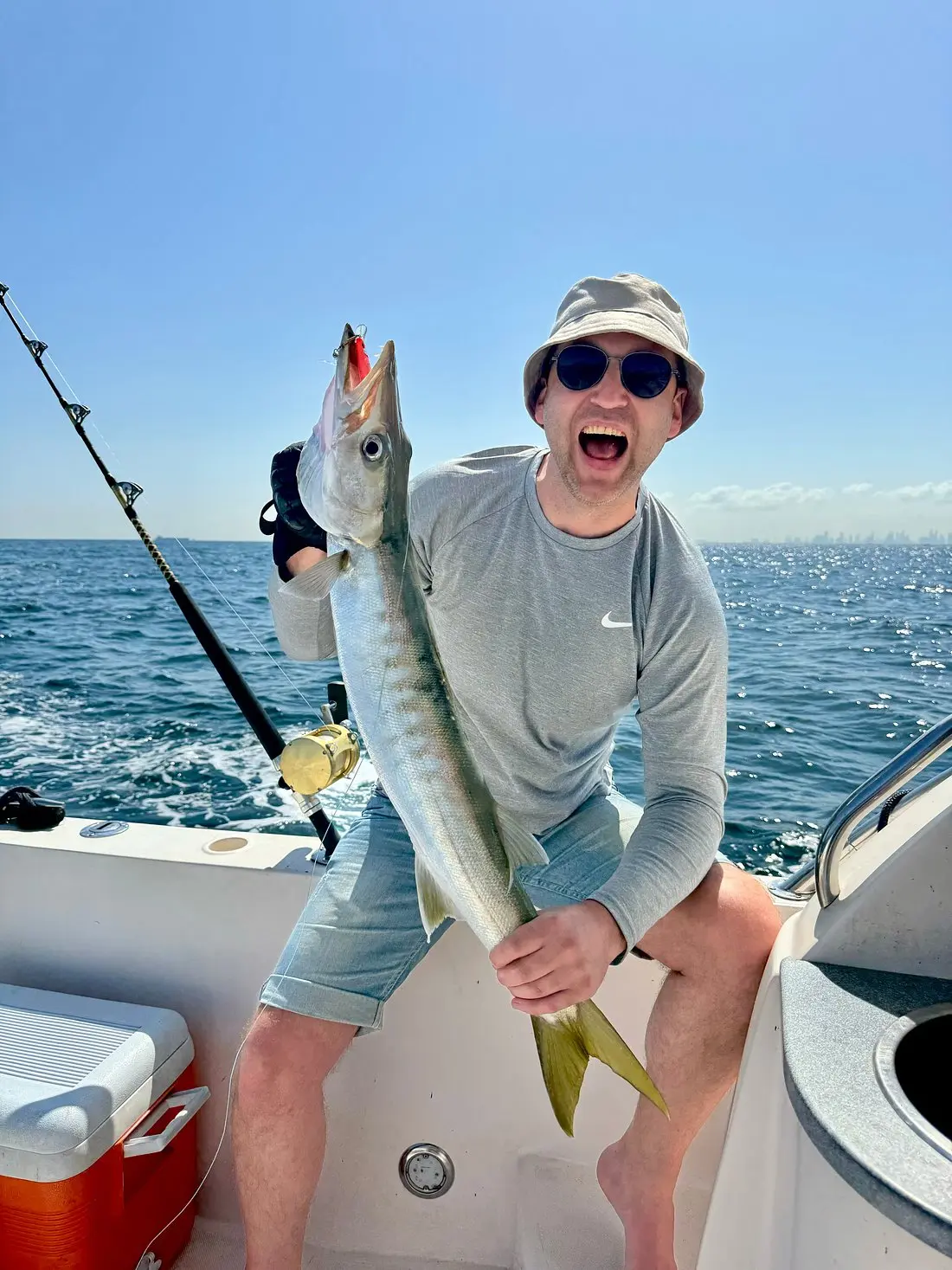 Guest celebrating successful catch during Dubai private fishing experience