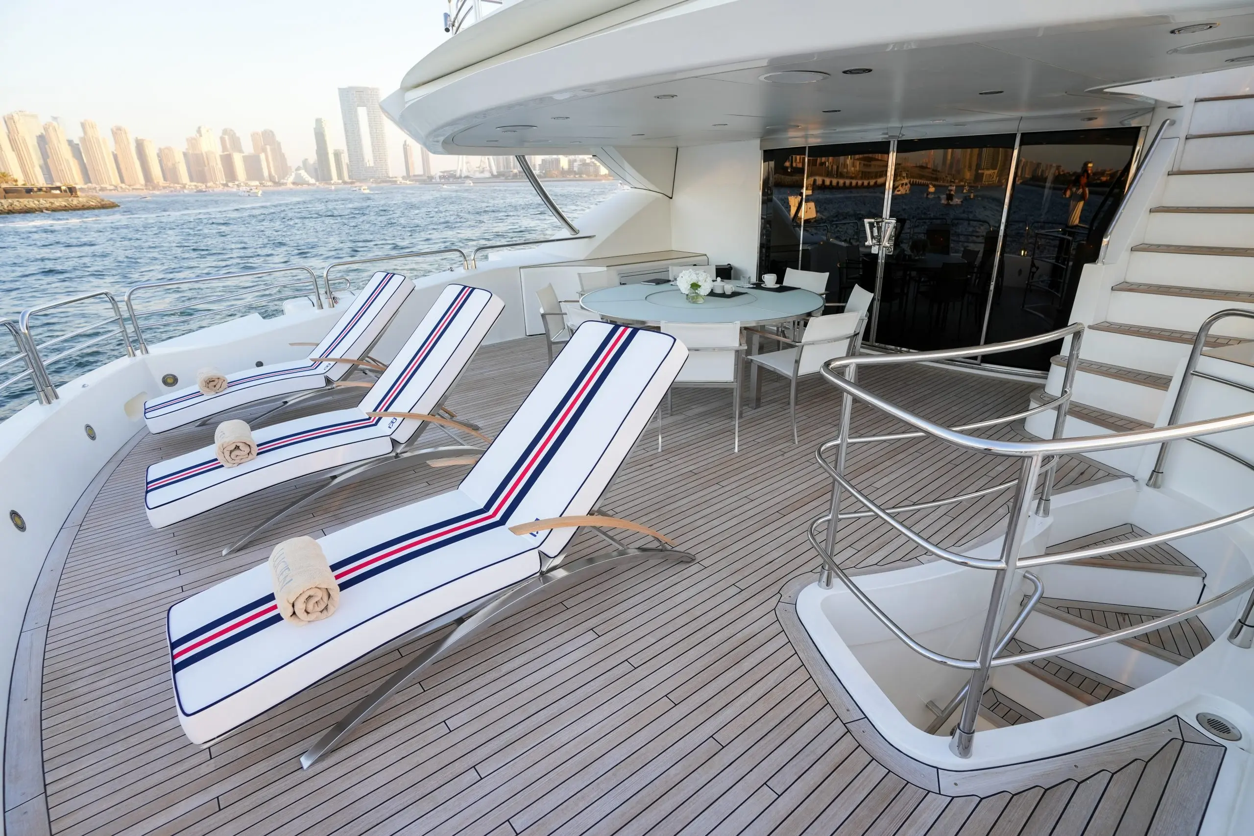 Sun loungers on teak deck of Sunseeker 131 yacht overlooking the sea
