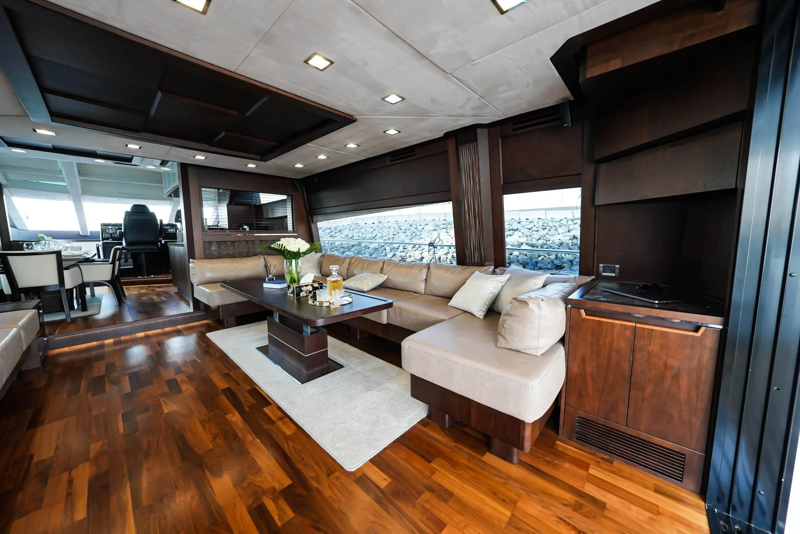 Galeon 780 F1 main salon with panoramic windows, wood flooring, and luxury seating