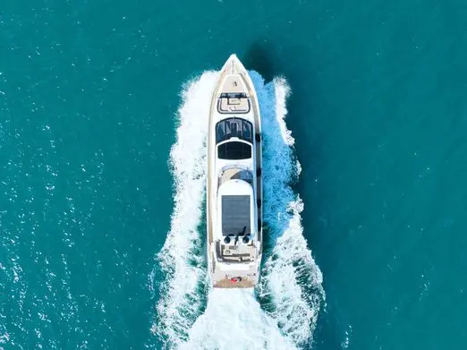 Aerial view of Galeon 780 F1 yacht underway leaving wake in deep blue ocean