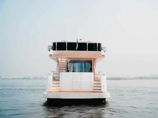 Front view of luxury yacht cruising on open sea for private yacht charter experience