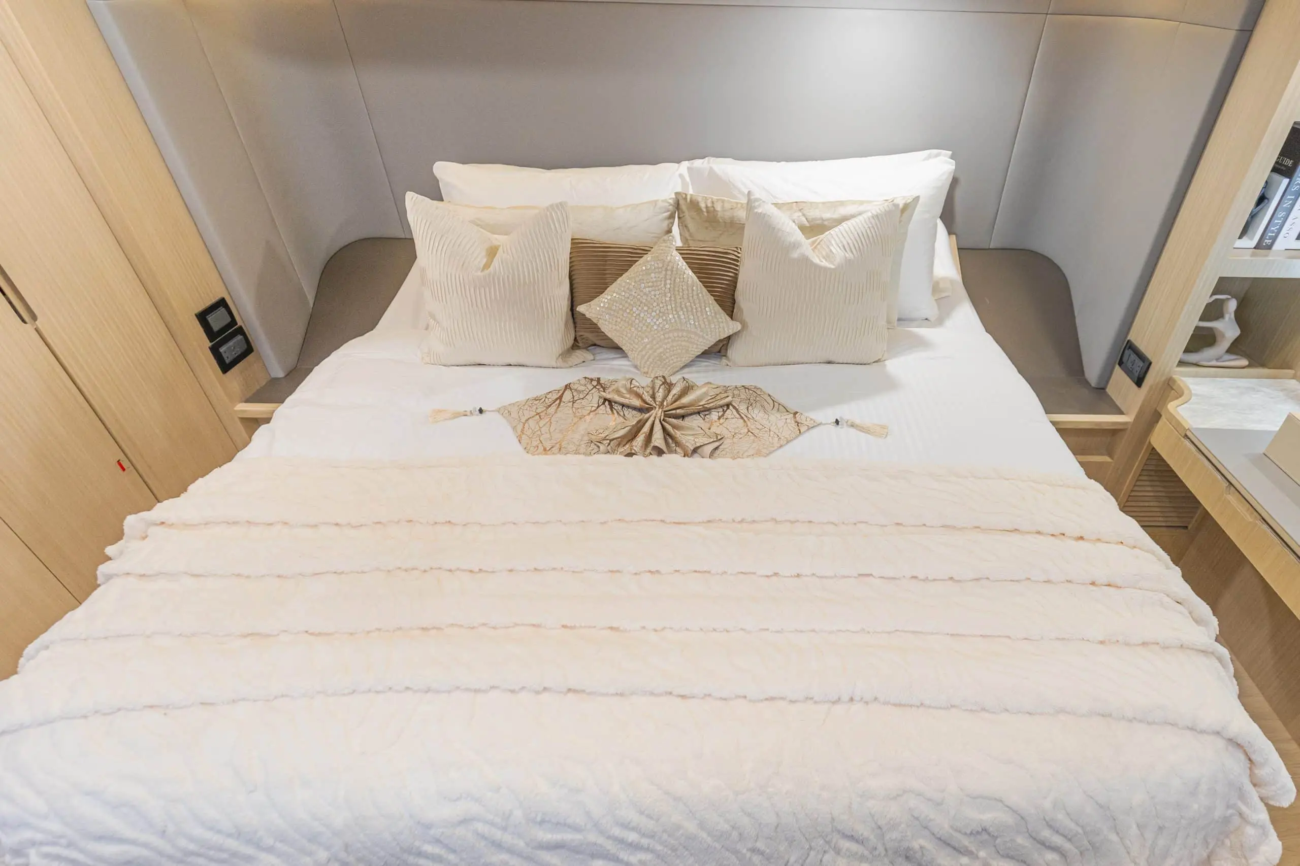 Close-up of Zirve 72 yacht double bed with luxury bedding and decorative pillows