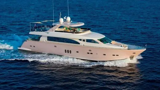Champagne-hulled flybridge motor yacht cruising through deep blue open water