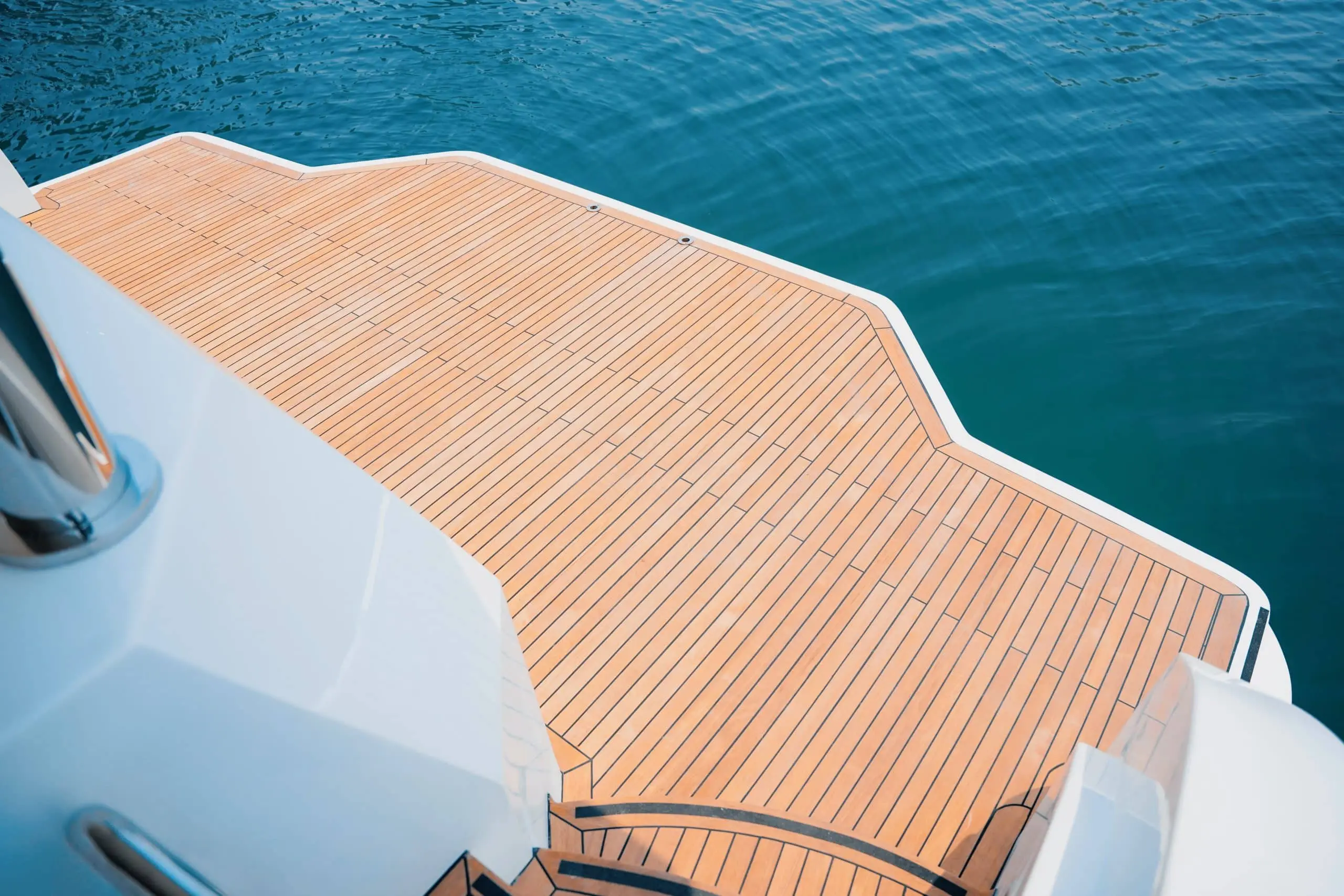 Carina 75 yacht teak swim platform and rear deck over turquoise water