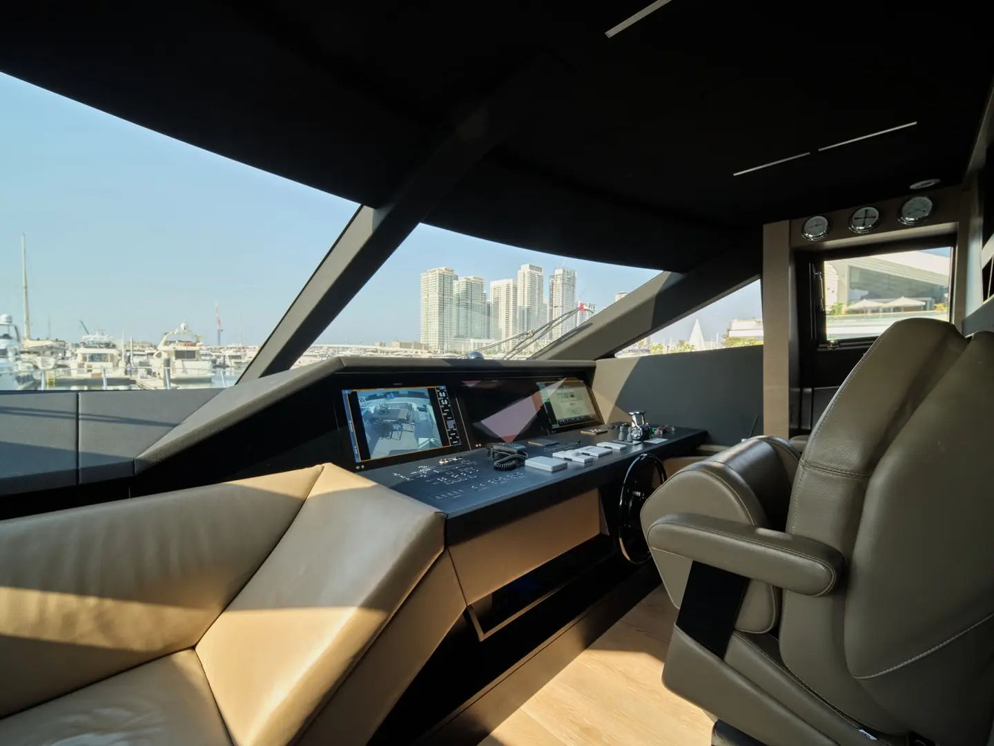 Helm station on Ferretti 780 yacht with captain seats and navigation controls