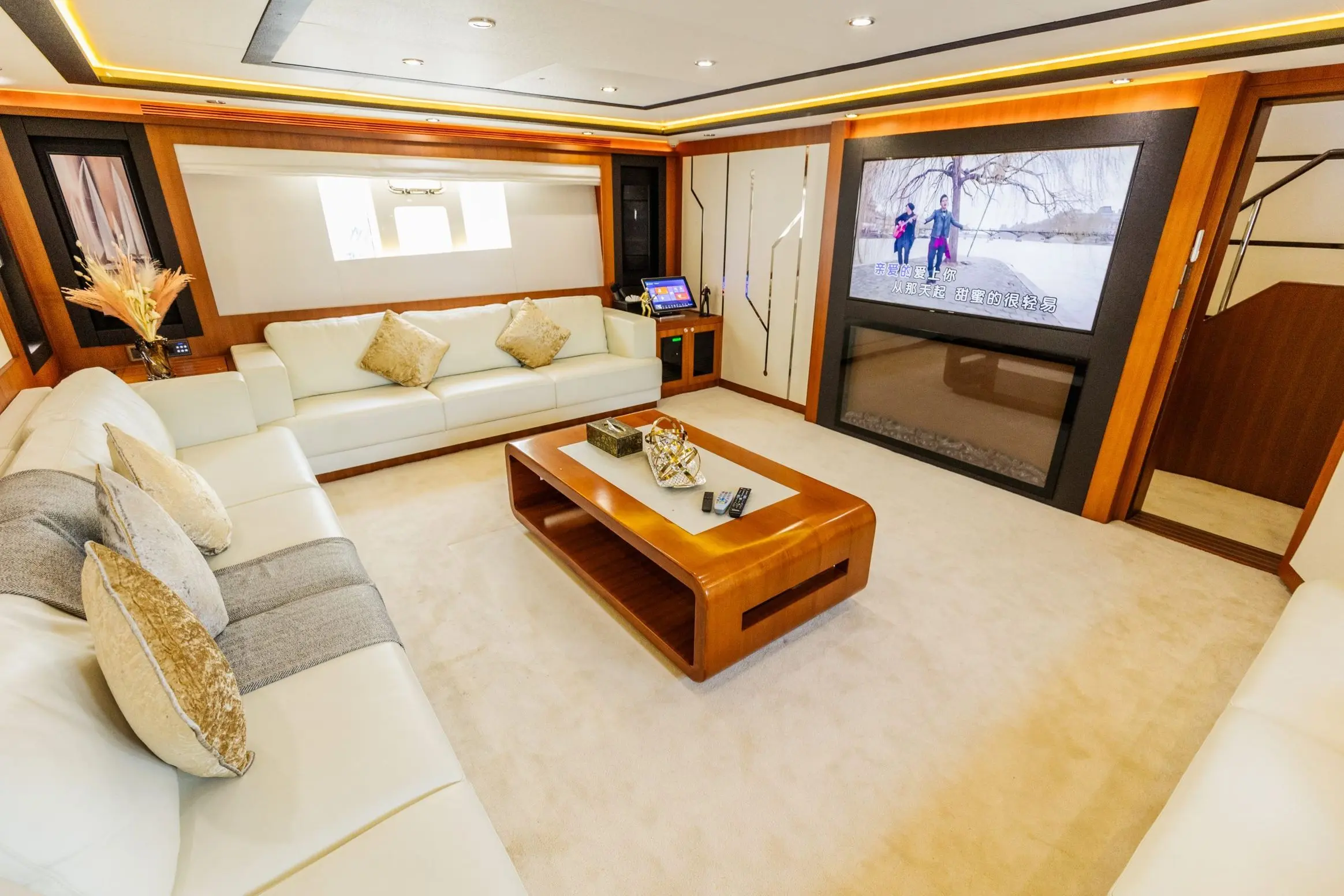 Cante 97 yacht VIP cabin lounge area with cream sofa and wooden table