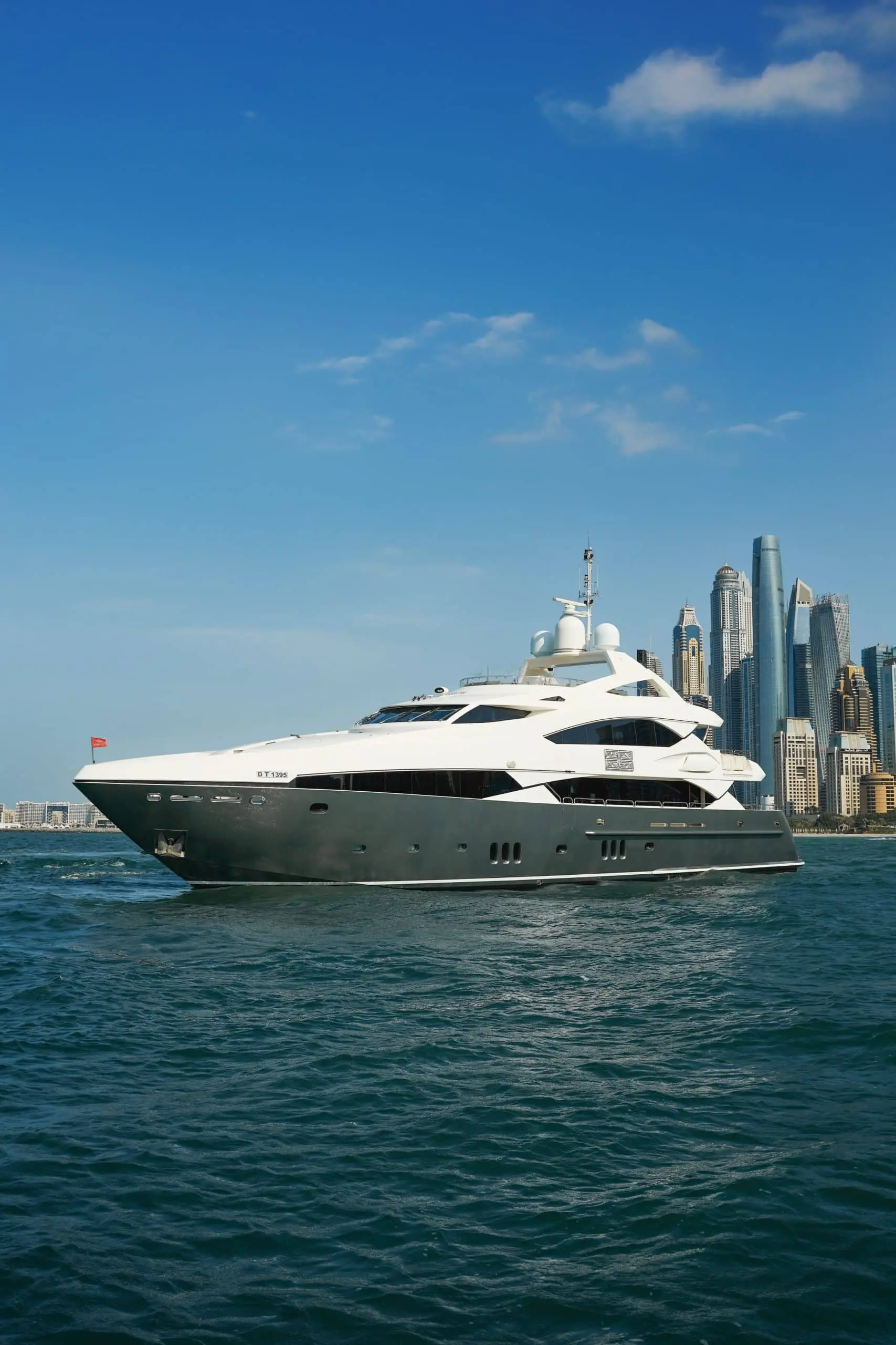 Aurora 130 yacht exterior cruising near Dubai skyline