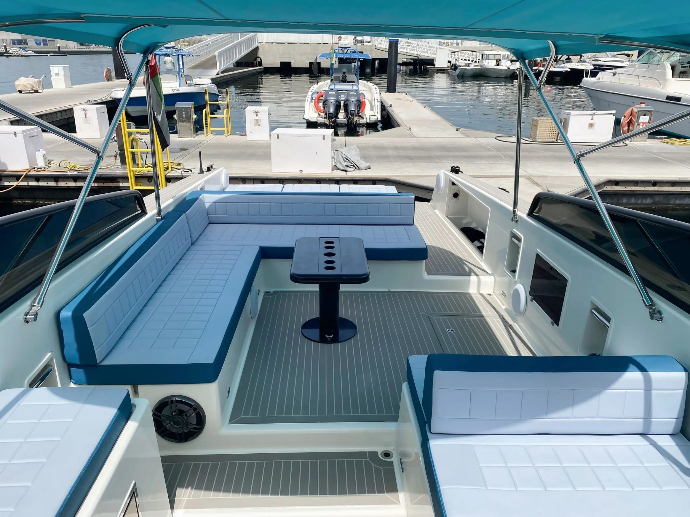 Von Dutch 40 yacht docked at Dubai Marina with outdoor seating