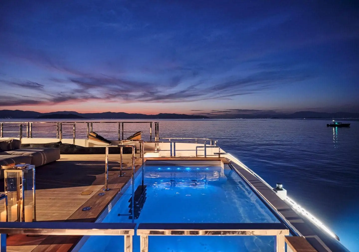 Sanlorenzo 500EXP aft pool illuminated at dusk, broker photo