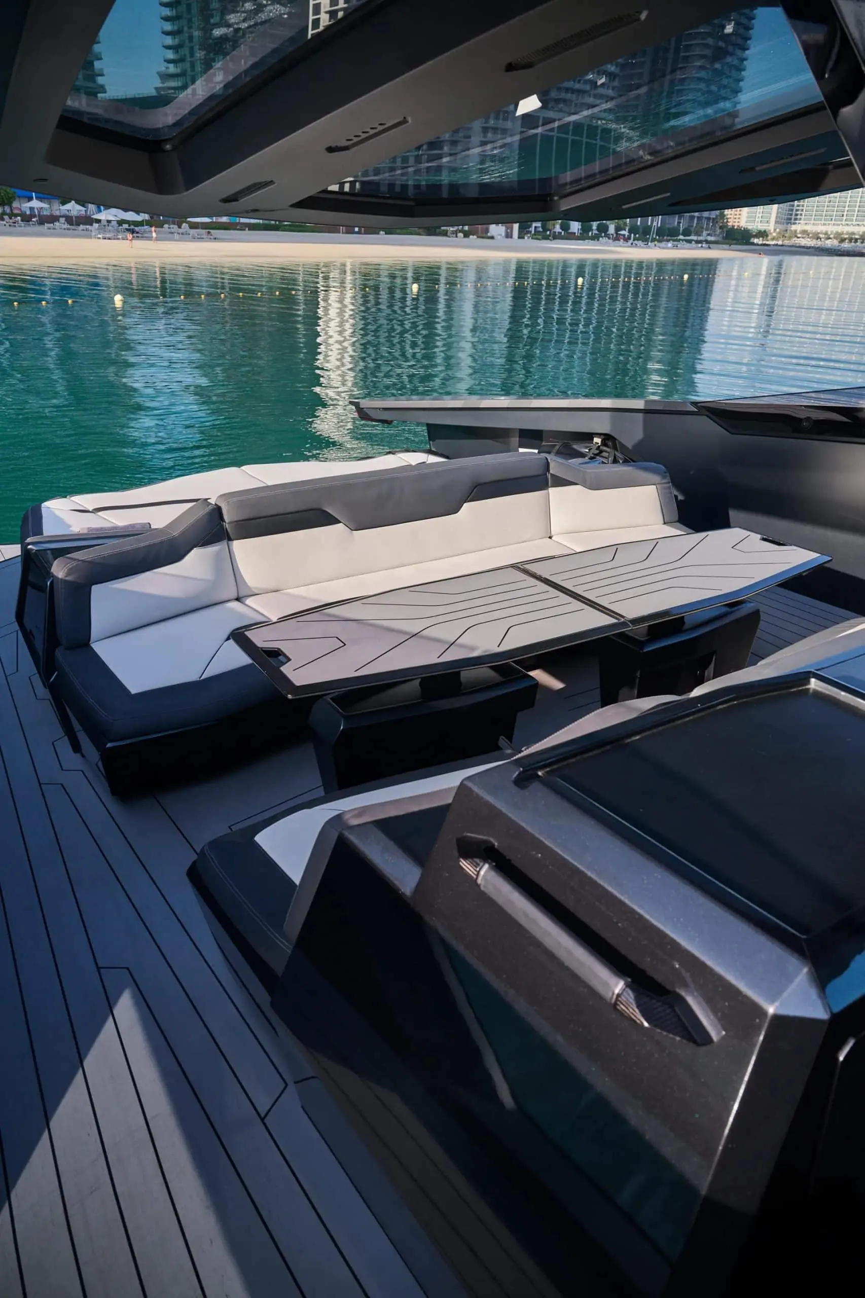 Lamborghini 63 yacht aft lounge with sunbeds and teak deck flooring