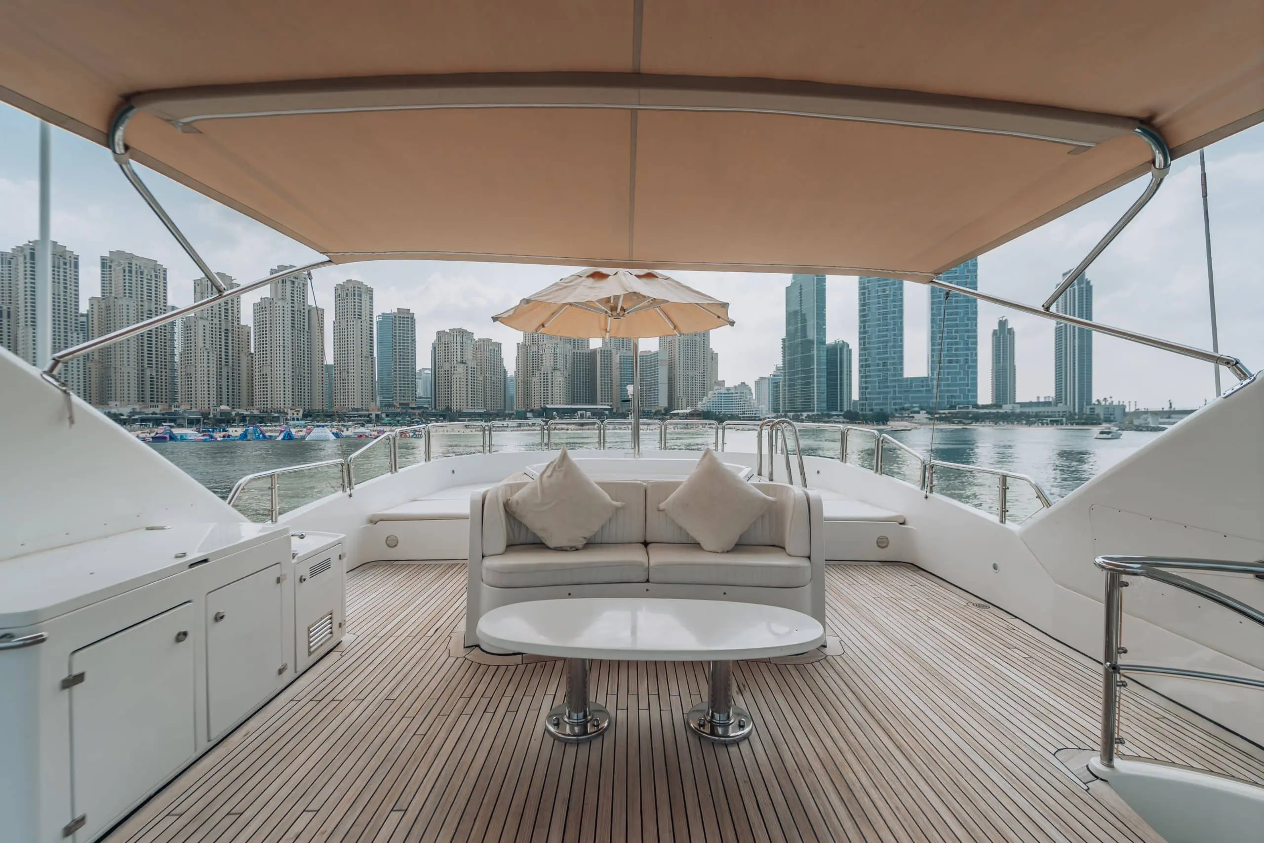 Yacht seating area with city skyline backdrop.