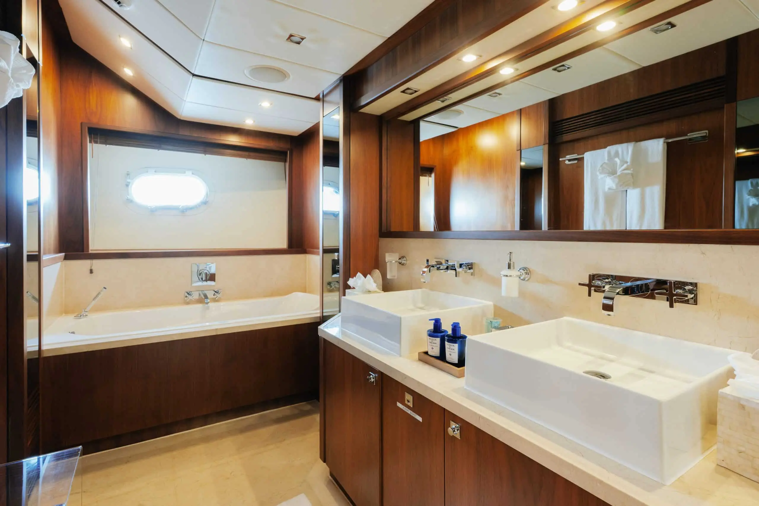 Aurora 130 yacht ensuite bathroom with marble vanity and wood cabinetry
