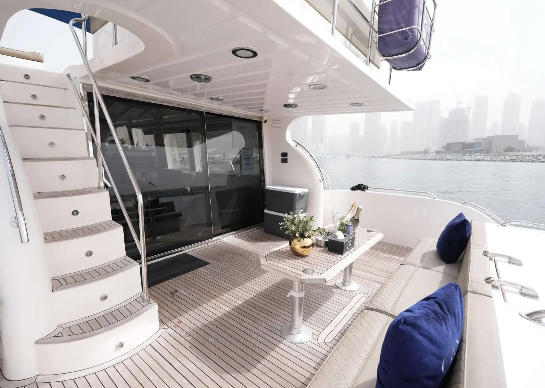 Belle 75 luxury yacht in Dubai Marina featuring spacious aft deck seating with skyline waterfront views
