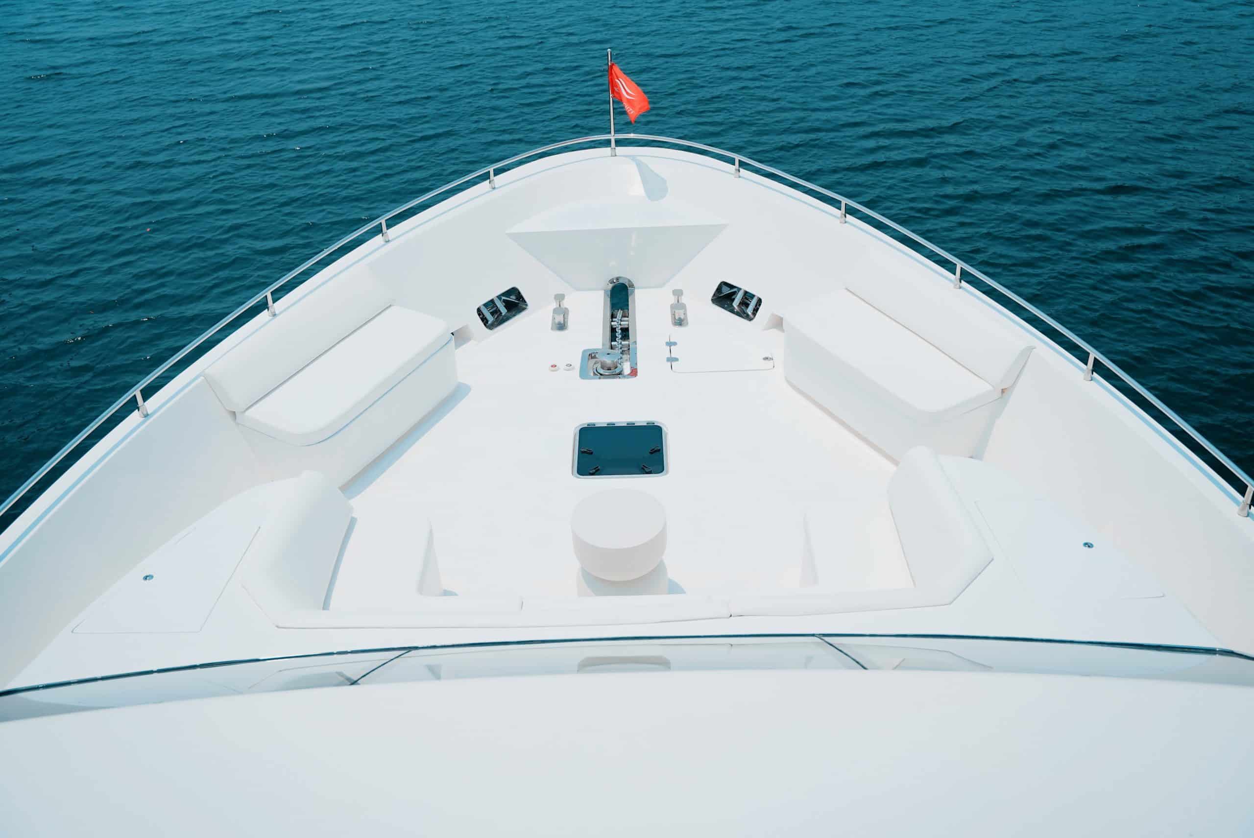 Carina 75 yacht bow seating and sun pad area overlooking calm blue water