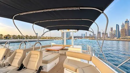 Empress 80 flybridge lounge under bimini with Dubai Marina skyline