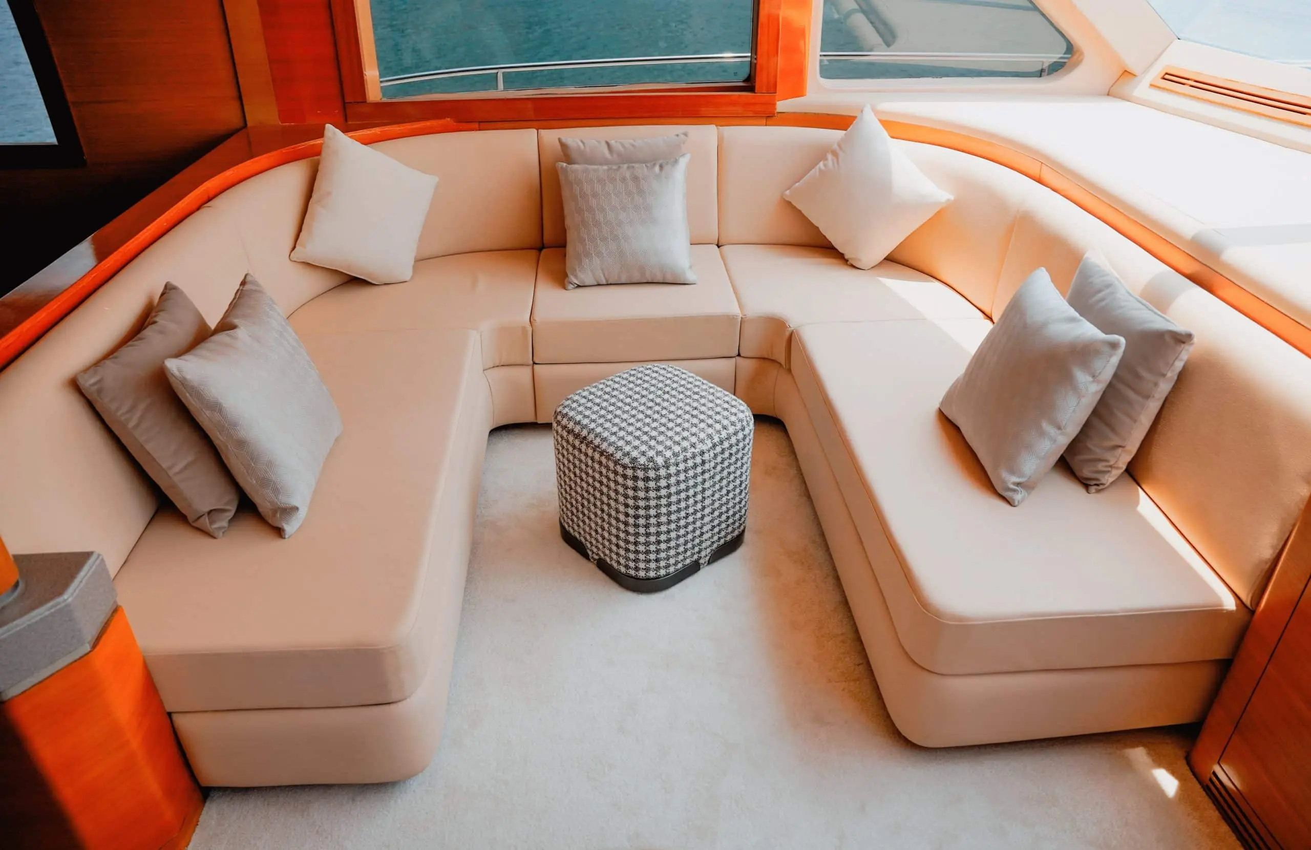 Carina 75 Luxury yacht interior lounge with cream U-shaped seating and central table