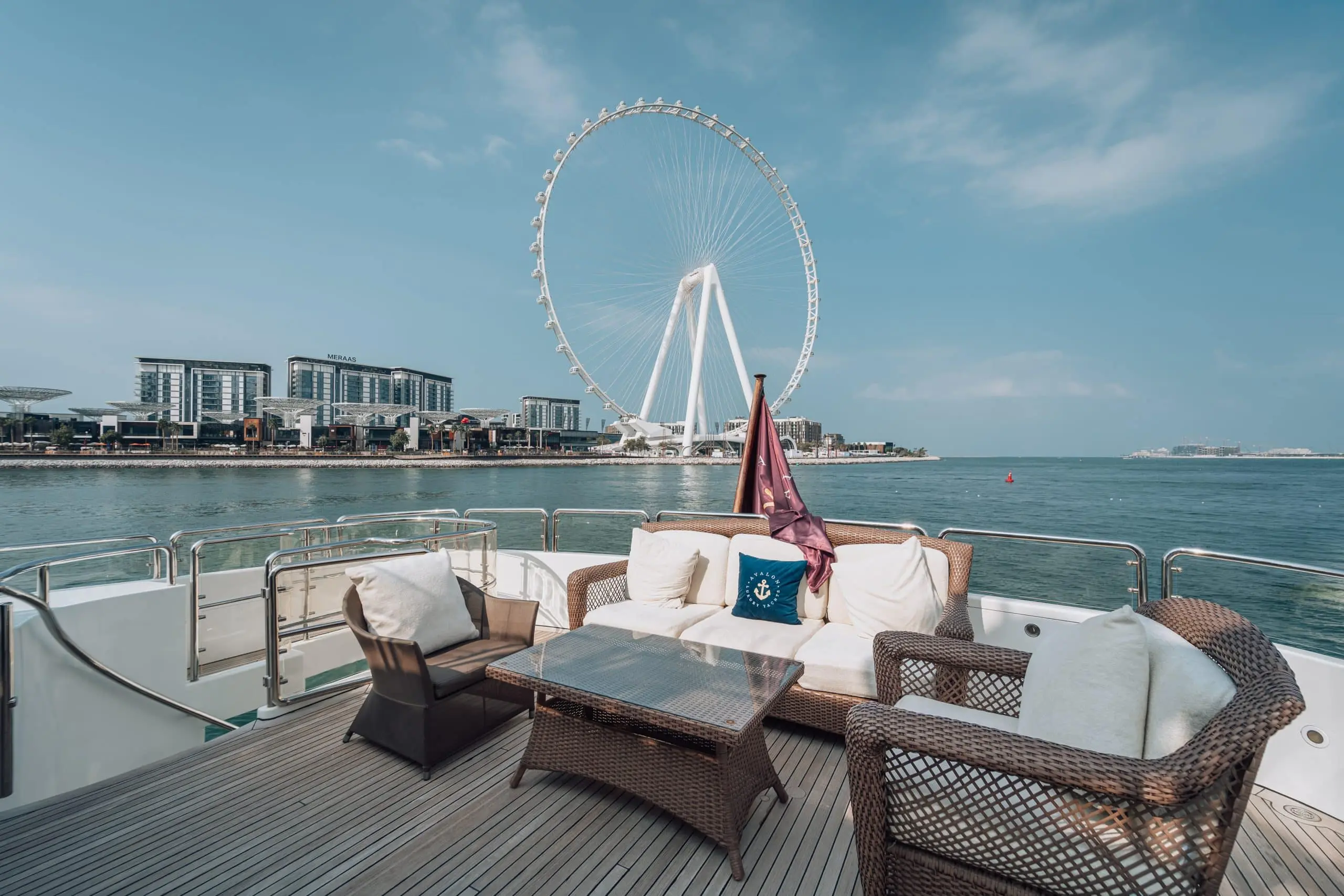 Yacht lounge seating area with sea view and Ain Dubai in the background, Dubai.
