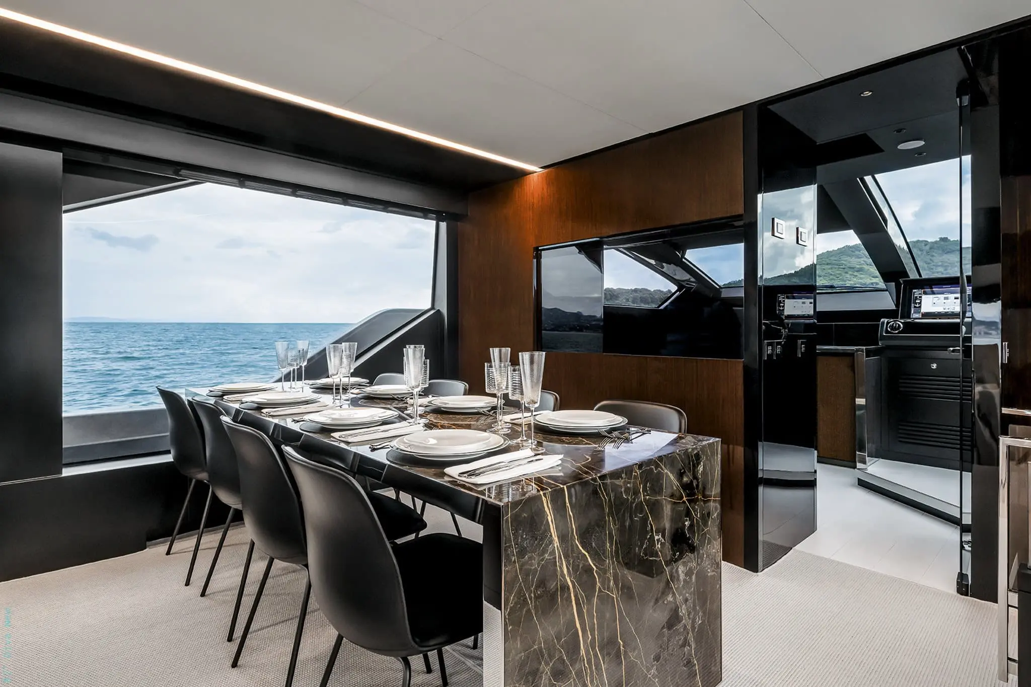 Riva 82 Diva formal dining area with marble table beside the helm