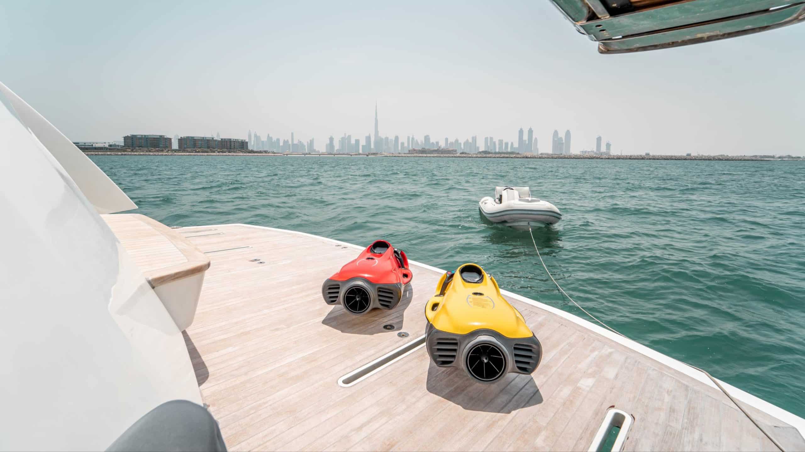 Jet skis on Dolce Vita yacht deck with Dubai skyline view during luxury yacht charter