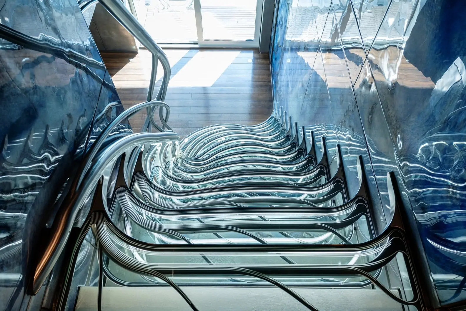 Heesen 5000 staircase detail with flowing polished steel steps