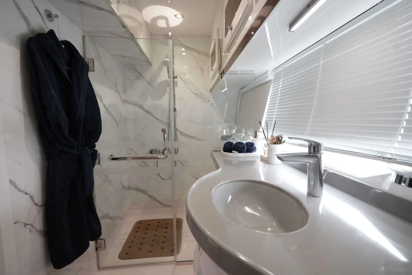 Belle 75 luxury yacht bathroom interior with sink, marble shower, and modern design