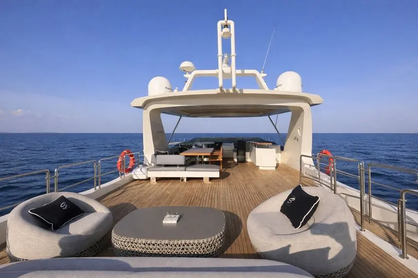 Azimut 88 flybridge aft lounge with round wicker seating