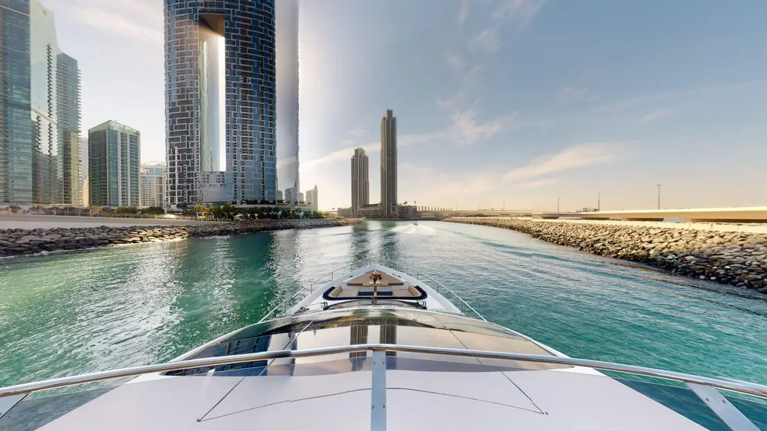 Galeon 780 F1 luxury yacht bow cruising view with city skyline and open water