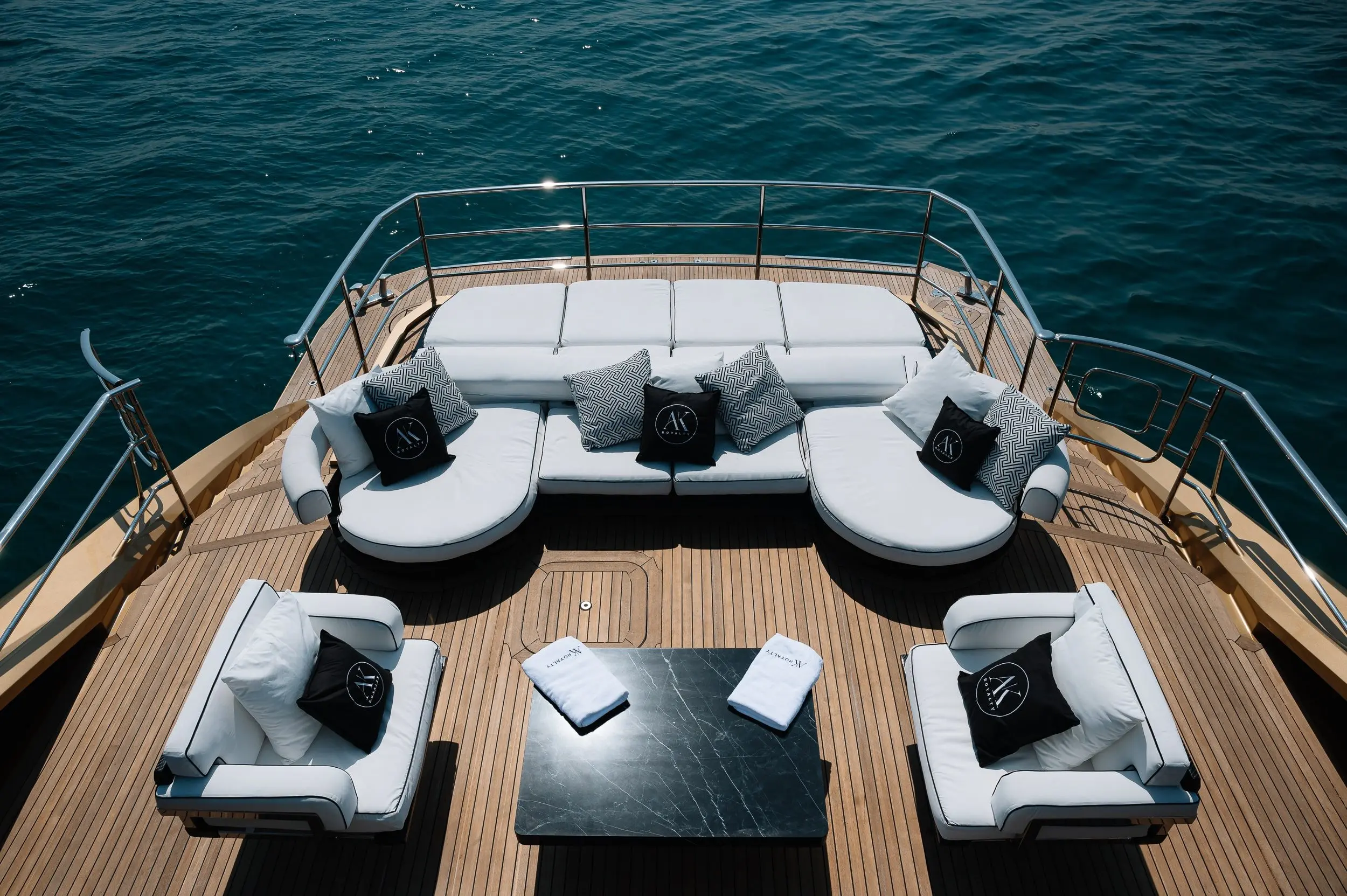 Luxury outdoor seating area on upper deck of Royalty 136 yacht