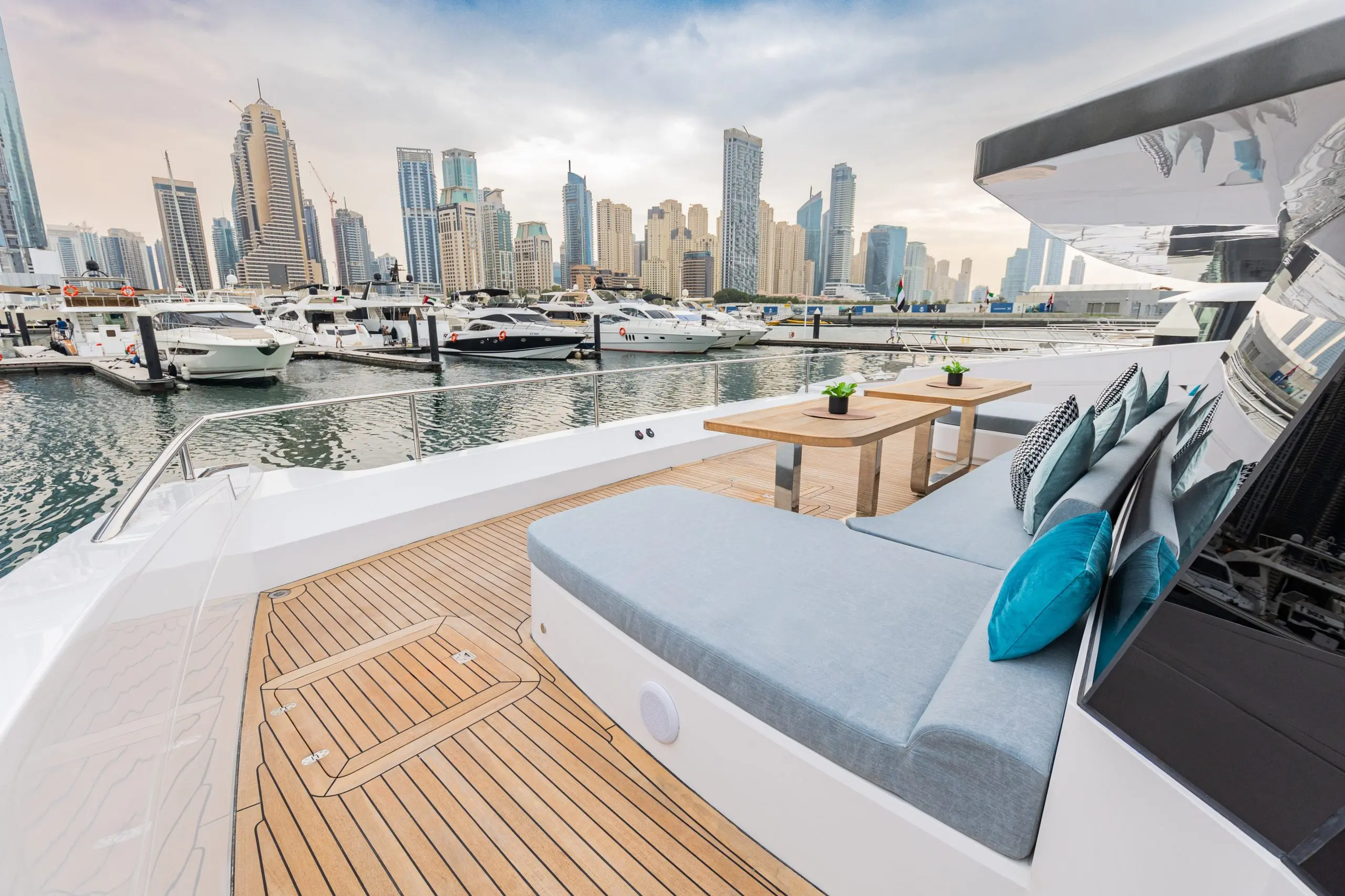 Zirve 72 luxury yacht deck lounge with city skyline view and modern seating