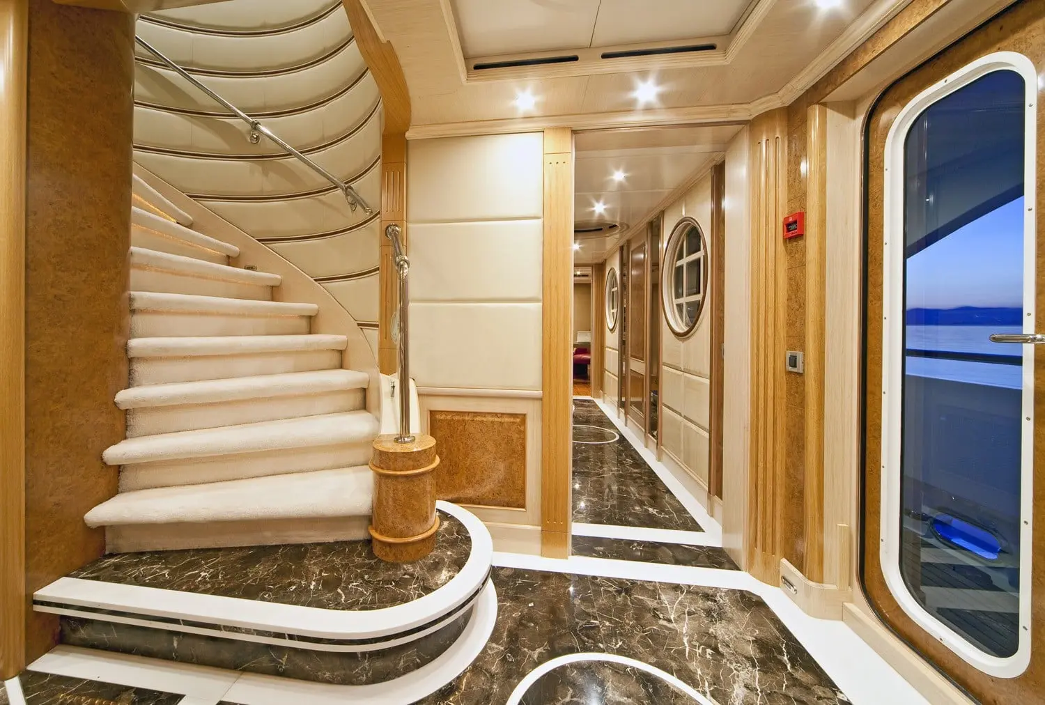 Athena 170 yacht interior staircase with wood and glass design