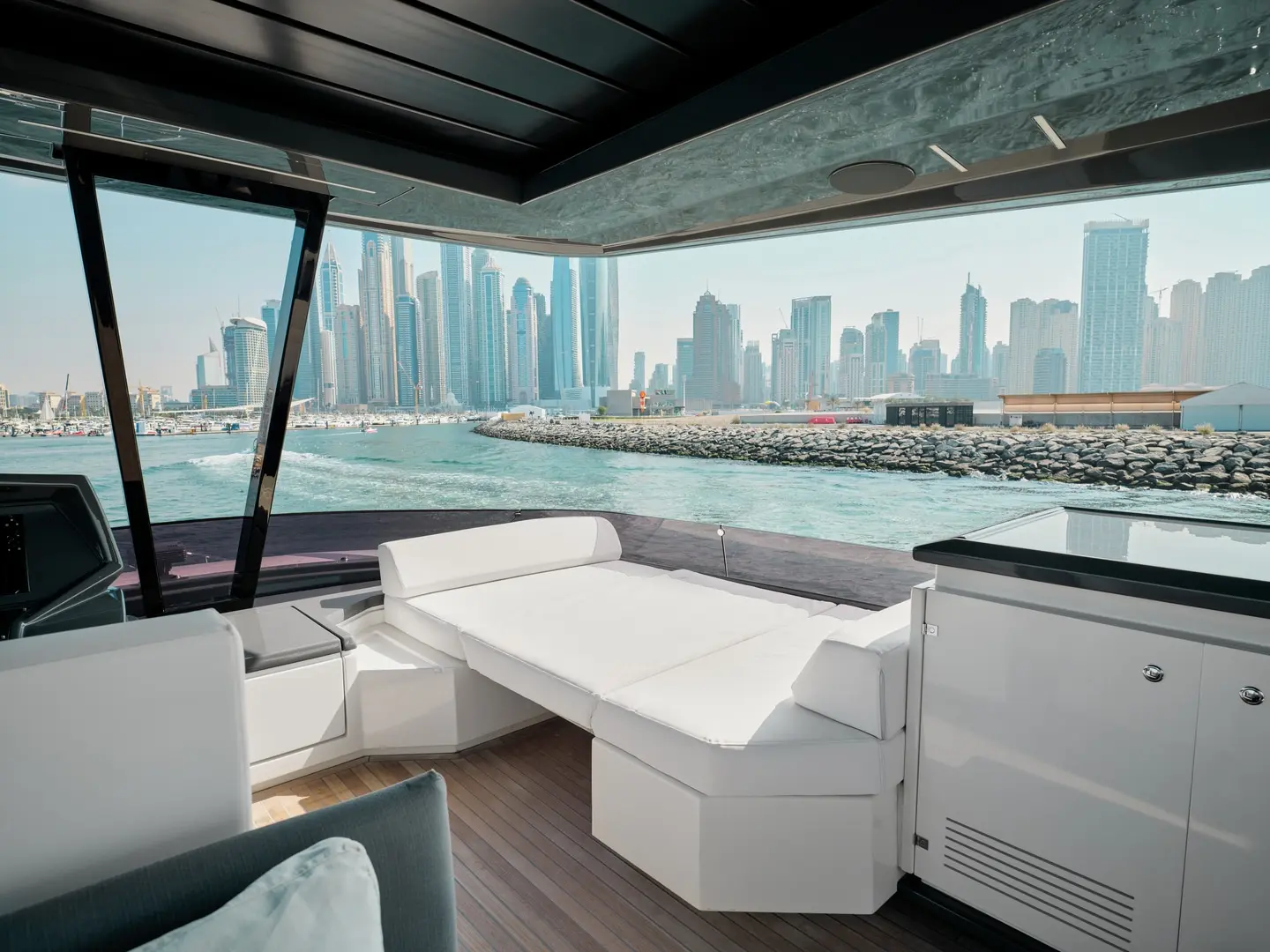 Enclosed upper lounge on Ferretti 780 yacht with Dubai skyline view